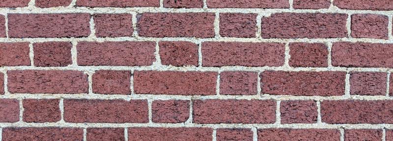 Abstract article image showing a wall built from red brick
